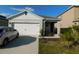 Charming single-story home with a two-car garage and well-maintained lawn at 1360 Berry Ln, Davenport, FL 33837
