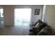 Inviting living room filled with natural light, a comfortable sofa, and neutral carpeting at 1360 Berry Ln, Davenport, FL 33837