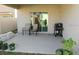 Cozy covered patio with chairs and a grill, perfect for outdoor relaxation and entertaining at 1360 Berry Ln, Davenport, FL 33837