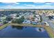 Aerial view of a charming neighborhood and lake providing privacy and scenic beauty at 1410 Rena Ln, Kissimmee, FL 34744
