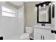 This bathroom has new white tile in the shower and new fixtures at 1410 Rena Ln, Kissimmee, FL 34744