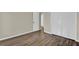 This bedroom features wood flooring and a large closet for ample storage at 1410 Rena Ln, Kissimmee, FL 34744
