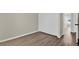 Bedroom features new flooring, with the closet to the left and the hallway to the right at 1410 Rena Ln, Kissimmee, FL 34744
