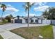 Inviting one-story home with a large driveway, attached garage, and well-manicured yard at 1410 Rena Ln, Kissimmee, FL 34744