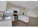 Modern kitchen features white cabinets, stainless steel appliances, and breakfast bar at 1410 Rena Ln, Kissimmee, FL 34744