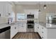 Modern updated kitchen with new stainless steel appliances and a breakfast bar at 1410 Rena Ln, Kissimmee, FL 34744