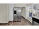 Spacious kitchen showcasing stainless steel refrigerator, wood flooring, and ample cabinet space at 1410 Rena Ln, Kissimmee, FL 34744