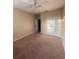 The bedroom features tan carpet, a ceiling fan and a closet with standard doors at 14257 Desert Haven St # Ge, Windermere, FL 34786