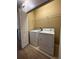 Bright laundry room featuring a full-size washer and dryer and built in wire shelving at 14257 Desert Haven St # Ge, Windermere, FL 34786