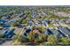 Aerial view of a house in a well-maintained community with mature trees and lush landscaping at 14637 Tanja King Blvd, Orlando, FL 32828