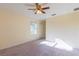 A cozy bedroom features a ceiling fan and a window to let in natural light at 14637 Tanja King Blvd, Orlando, FL 32828