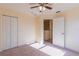 This bedroom features carpet, a ceiling fan, and a closet for ample storage space at 14637 Tanja King Blvd, Orlando, FL 32828