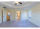 Spacious bedroom with tray ceiling, ceiling fan, bright windows, and multiple entrances at 14637 Tanja King Blvd, Orlando, FL 32828