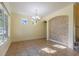 Well-lit dining room with tile flooring, chandelier, and interior stone archway at 14637 Tanja King Blvd, Orlando, FL 32828