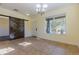 Spacious dining area with tiled flooring, natural light, and a modern rustic barn door at 14637 Tanja King Blvd, Orlando, FL 32828