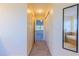 Hallway leading to the primary bedroom and bathroom with a view of the soaking tub and dual-sink vanity at 14637 Tanja King Blvd, Orlando, FL 32828