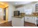 Charming kitchen features granite countertops, stainless steel appliances, and a unique sliding barn door at 14637 Tanja King Blvd, Orlando, FL 32828