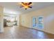 Spacious living room with ceramic tile flooring, ceiling fan and doors leading to the backyard at 14637 Tanja King Blvd, Orlando, FL 32828
