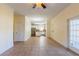 Open living room area with ceramic tile flooring and views into the kitchen with stainless steel appliances at 14637 Tanja King Blvd, Orlando, FL 32828