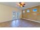 Living room with tile floors, ceiling fan and french doors leading to an outdoor area at 14637 Tanja King Blvd, Orlando, FL 32828
