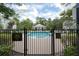 Fenced community pool with a sign, showcasing a clean and inviting swimming area at 14637 Tanja King Blvd, Orlando, FL 32828
