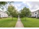 Well-maintained townhomes with grassy lawns and sidewalks offer a serene community environment at 14637 Tanja King Blvd, Orlando, FL 32828