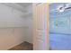 View of the main bedroom from a walk-in closet featuring wire shelving and neutral carpeting at 14637 Tanja King Blvd, Orlando, FL 32828