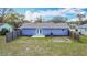 Aerial view of the fenced backyard with patio, showcasing the blue exterior of the home at 1507 Georgia Ave, St Cloud, FL 34769