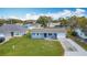 Lovely blue single-story house boasting a manicured front lawn and an inviting driveway at 1507 Georgia Ave, St Cloud, FL 34769