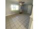 Bright living room featuring neutral tile floors, a ceiling fan, and natural light at 1507 Georgia Ave, St Cloud, FL 34769