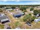 Aerial view of the home showcasing the sunroom, fenced yard, and mature trees at 152 Harrison St, Lake Wales, FL 33859