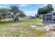 Expansive backyard featuring mature trees and multiple storage sheds at 152 Harrison St, Lake Wales, FL 33859