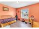Cozy bedroom with a bright color scheme, a window and desk space at 152 Harrison St, Lake Wales, FL 33859