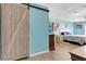 Bright bedroom with a sliding barn door and wood-look flooring at 152 Harrison St, Lake Wales, FL 33859