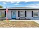 Close-up of a well maintained single-story home with a bright blue front door at 152 Harrison St, Lake Wales, FL 33859