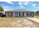Charming single-story home with a bright blue front door and an American flag at 152 Harrison St, Lake Wales, FL 33859