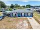 Well-kept one-story home featuring a manicured front lawn, modern windows, and a welcoming blue front door at 152 Harrison St, Lake Wales, FL 33859