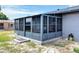 Enclosed sunroom addition with screened windows and a concrete foundation at 152 Harrison St, Lake Wales, FL 33859