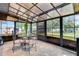 Enclosed sunroom with translucent ceiling and brick floors featuring a glass table with 4 chairs at 152 Harrison St, Lake Wales, FL 33859