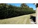 Manicured backyard with well maintained bushes and lawn at 156 Grand Canal Dr, Poinciana, FL 34759