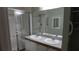 Bathroom featuring a double sink vanity, a large mirror, and a shower with sliding glass doors at 156 Grand Canal Dr, Poinciana, FL 34759