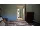 Bedroom with views to the entry hall and bathroom, featuring a four-poster bed and ample closet space at 156 Grand Canal Dr, Poinciana, FL 34759
