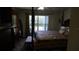 Cozy bedroom featuring a four-poster bed, a large window, and ample closet space at 156 Grand Canal Dr, Poinciana, FL 34759