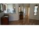 Welcoming foyer with tile flooring, decorative mirrors, and a view into the kitchen with stainless steel appliances at 156 Grand Canal Dr, Poinciana, FL 34759