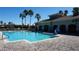 The community features a pool surrounded by palm trees and comfortable lounge chairs at 156 Grand Canal Dr, Poinciana, FL 34759