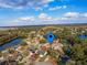 An aerial view of the neighborhood showcasing mature landscaping, nearby homes, and a serene lake at 206 Memphis Pl, St Cloud, FL 34769