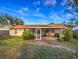 A view of the backyard and screened in patio with outdoor seating and a barbecue grill at 206 Memphis Pl, St Cloud, FL 34769