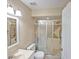 Bathroom featuring a toilet, vanity sink, shower with glass doors and neutral walls at 206 Memphis Pl, St Cloud, FL 34769