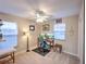 Neutral bedroom featuring a desk with dual monitors, ceiling fan, and natural light from the large window at 206 Memphis Pl, St Cloud, FL 34769