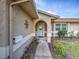 Charming home exterior with a welcoming front door, decorative accents, a mailbox, and manicured landscaping at 206 Memphis Pl, St Cloud, FL 34769